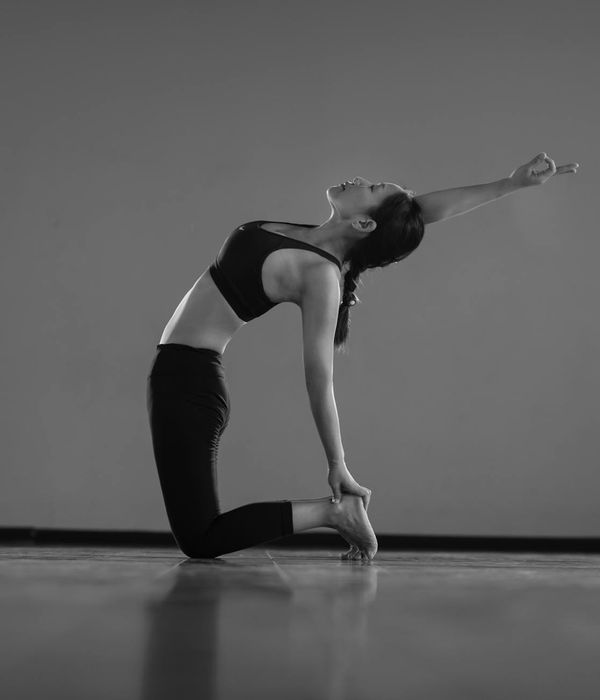 Woman in a graceful yoga pose showing balance and calm.